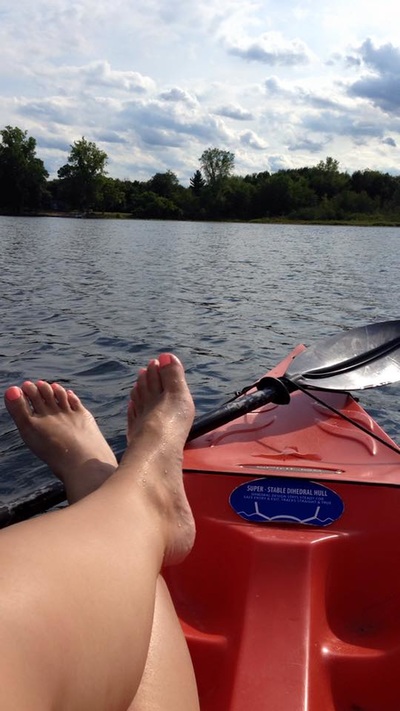 feet on a kayak in water