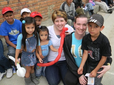 Mrs. Ruble posing with kids in Colombia